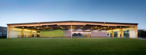 Covered open-air playcourt reuses an abandoned warehouse structure. Padron Elementary Austin ISD.