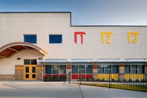 Large classroom windows and new entry canopy transform old loading dock into pre-school. Padron Elementary AISD.
