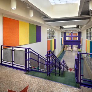 Double-height corridors orient all circulation through this urban school built from an abandoned warehouse.