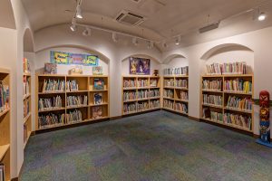 School library features arched niches for children’s book shelves. Good Shepherd Episcopal School, Austin.