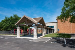 Covered drop-off and walkway for church day school. Woodlawn Baptist, Austin by Heimsath Architects.