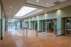 New Connection Center addition links existing church buildings and accommodates multi-use functions. By Heimsath Architects.