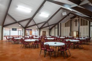 New fellowship hall from renovated sanctuary, bright ceiling and stained concrete floor.