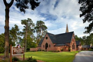 Modern red brick church with traditional form. Holy Trinity Episcopal by Heimsath Architects.