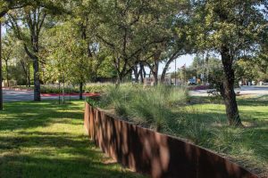 Contemporary landscape design uses berms and plantings to screen busy traffic. Shepherd of the Hills Lutheran Church.