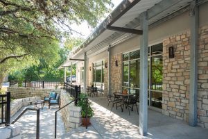 Outdoor gathering spaces connect renovated gym to upgraded church parking. Shepherd of the Hills by Heimsath Architects.