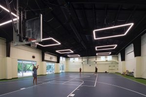 Church gym renovation adds natural light, innovative lighting, and durable sportsfloor. Designed by Heimsath Architects.