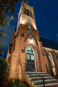 Dramatic night shot of historic brick church steeple. St. John’s Episcopal, Tallahassee, Florida.
